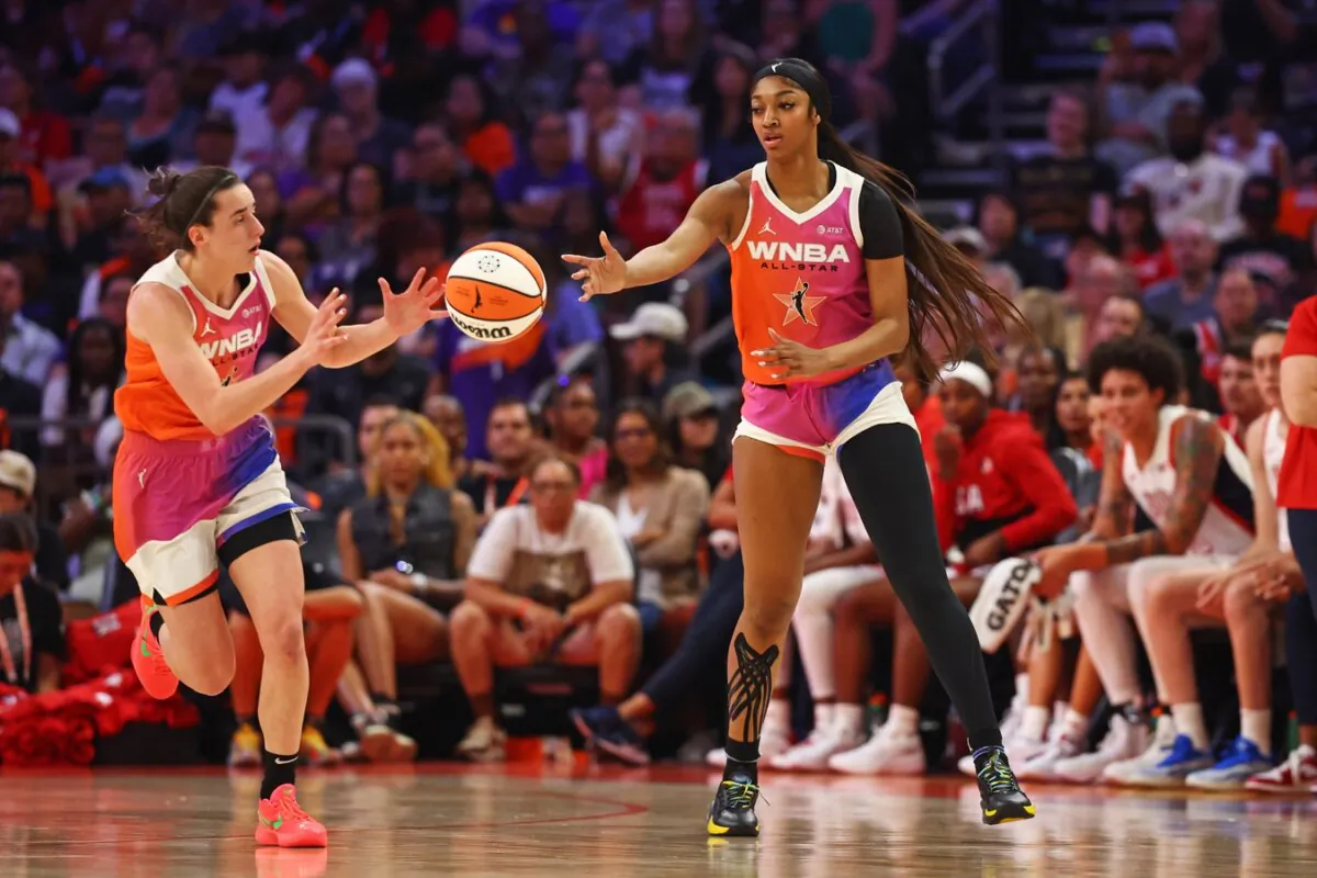 Standout WNBA rookies Angel Reese (R) and Caitlin Clark hook up for the league's All-Stars against the U.S. Olympic team in Phoenix, Ariz., on July 20, 2024. (Mark J. Rebilas/USA TODAY via Field Level Media)