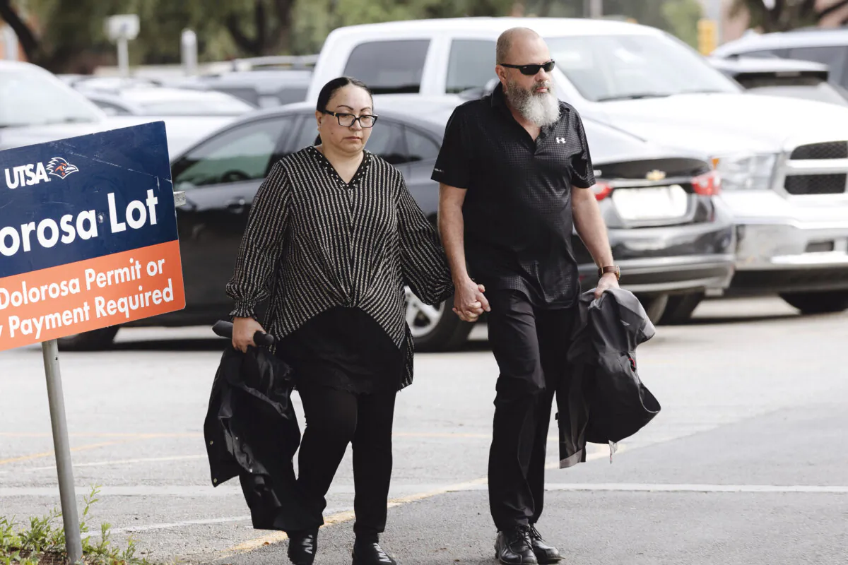 Janet Yamanaka Mello (L), an ex-civilian employee of the U.S. Army convicted of stealing $109 million from a youth development program for children of military families, and her husband Mark Mello walk into the federal courthouse in San Antonio, Texas, on July 23, 2024. (Christopher Lee/The San Antonio Express-News via AP)