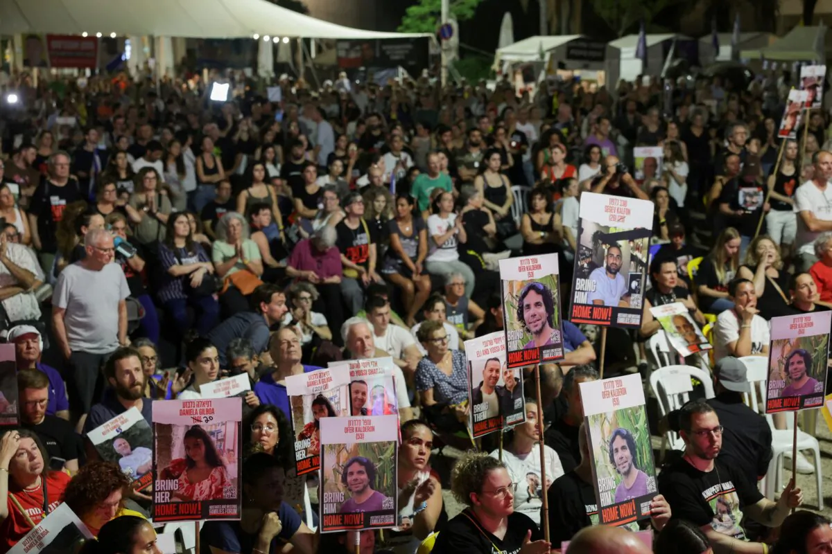 Israelis and hostage families watch a screening of Israeli Prime Minister Benjamin Netanyahu as he addresses Congress on a visit to the United States, at the so-called Hostages Square, in Tel Aviv, Israel, on July 24, 2024. (Ricardo Moraes/Reuters)