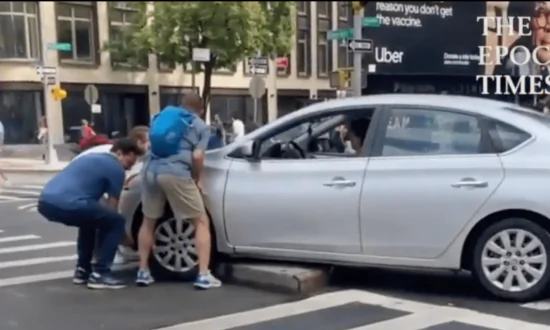 Helpful New Yorkers Come Together to Help Free a Car Stuck on the Curb