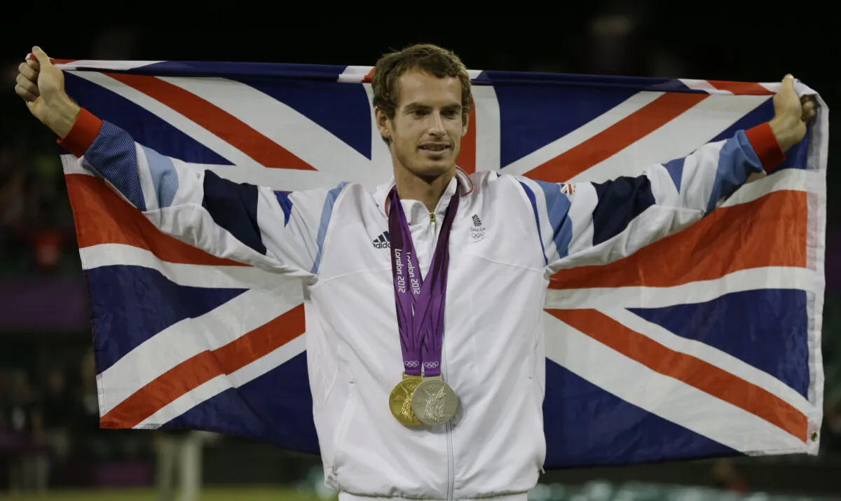Andy Murray of Great Britain poses with his gold and silver medals in tennis at the All England Lawn Tennis Club in Wimbledon, London, at the 2012 Summer Olympics, on Aug. 5, 2012. (Mark Humphrey/AP Photo)
