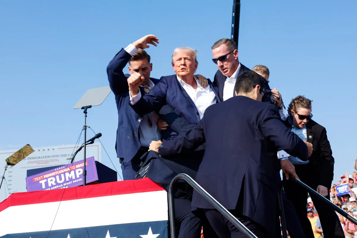 Republican presidential candidate former President Donald Trump is rushed offstage after an assassination attempt during a rally in Butler, Pa., on July 13, 2024. (Anna Moneymaker/Getty Images)