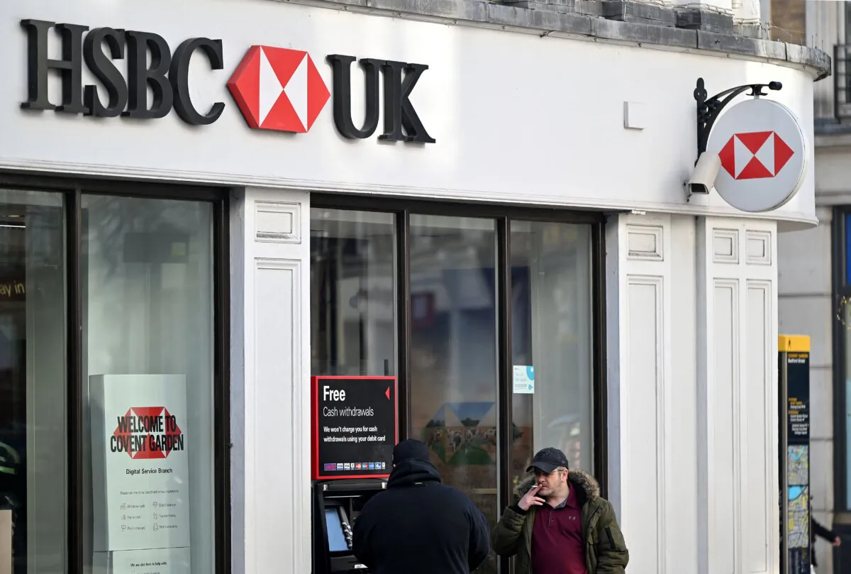 A customer uses an ATM machine outside a branch of HSBC bank in central London, on Feb. 14, 2023. (Justin Tallis/AFP via Getty Images)