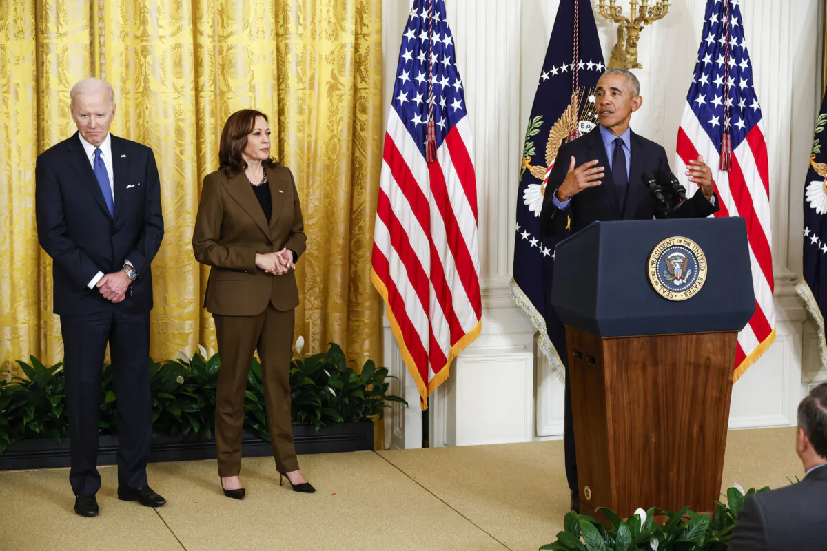 (L-R) President Joe Biden and Vice President Kamala Harris look on as former President Barack Obama speaks during an event to mark the 2010 passage of the Affordable Care Act in the East Room of the White House in Washington, on April 5, 2022. (Chip Somodevilla/Getty Images)