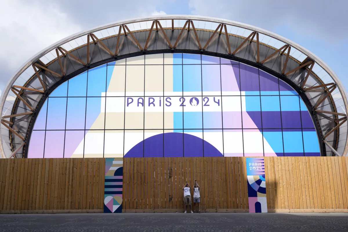 Tourists photograph near the Champ-de-Mars Arena, ahead of the 2024 Summer Olympics in Paris, France, on July 24, 2024. (Eugene Hoshiko/AP Photo)