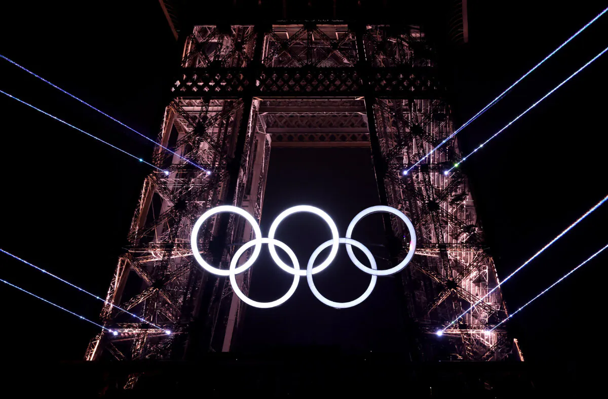A light show takes place as The Olympic Rings on the Eiffel Tower are illuminated during the opening ceremony of the Olympic Games Paris 2024 at Place du Trocadero in Paris, France, on July 26, 2024. (Hector Vivas/Getty Images)