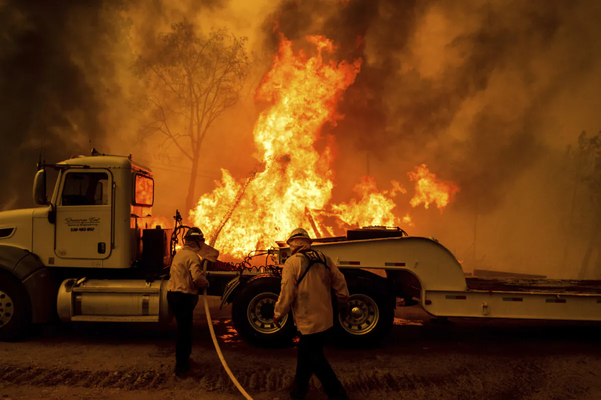 Firefighters spray water as the Park Fire tears through the Cohasset community in Butte County, Calif., on July 25, 2024. (Noah Berger/AP Photo)