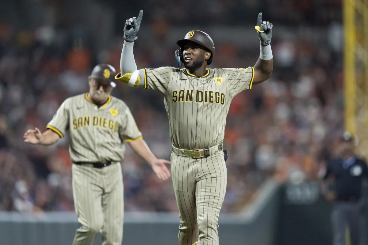 San Diego Padres' Jurickson Profar (R) celebrates after hitting a home run during the ninth inning of a baseball game against the Baltimore Orioles in Baltimore on July 26, 2024. (Stephanie Scarbrough/AP Photo)