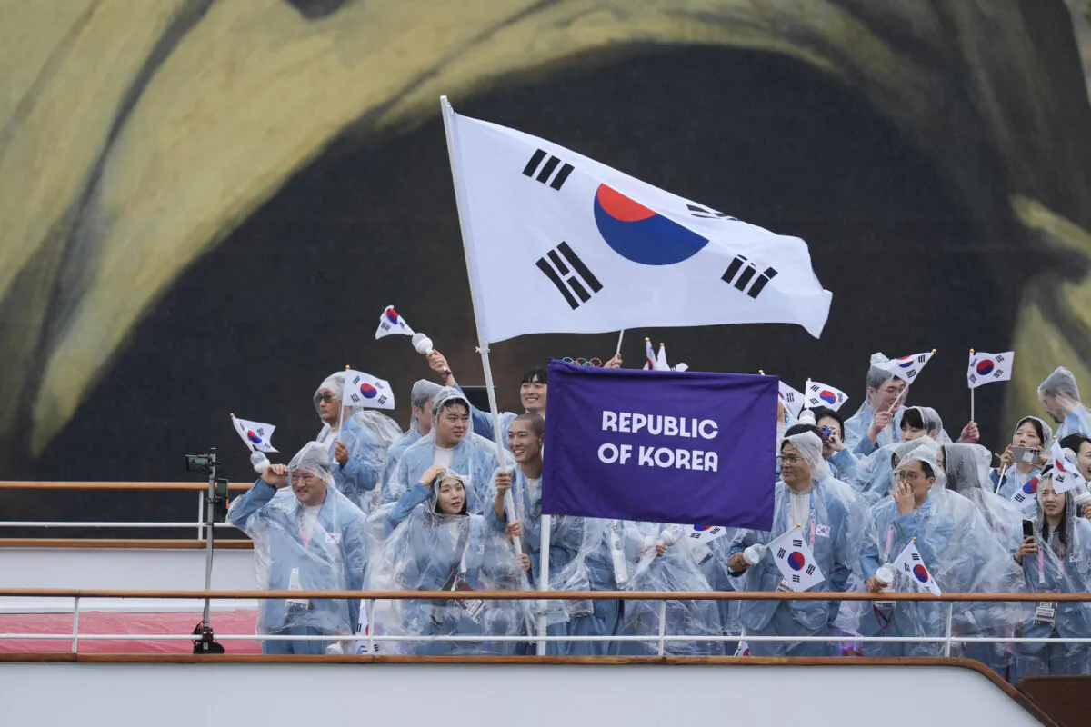 The boat carrying team South Korea makes its way down the Seine in Paris, France, during the opening ceremony of the 2024 Summer Olympics on July 26, 2024. (Rebecca Blackwell/AP Photo)