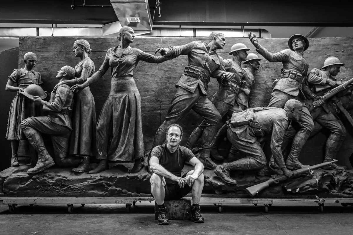 Master sculptor Sabin Howard sits in front of the World War I Memorial relief he sculpted that will be installed in Washington this year, on June 12, 2020. (Courtesy of Traci Slatton Howard)
