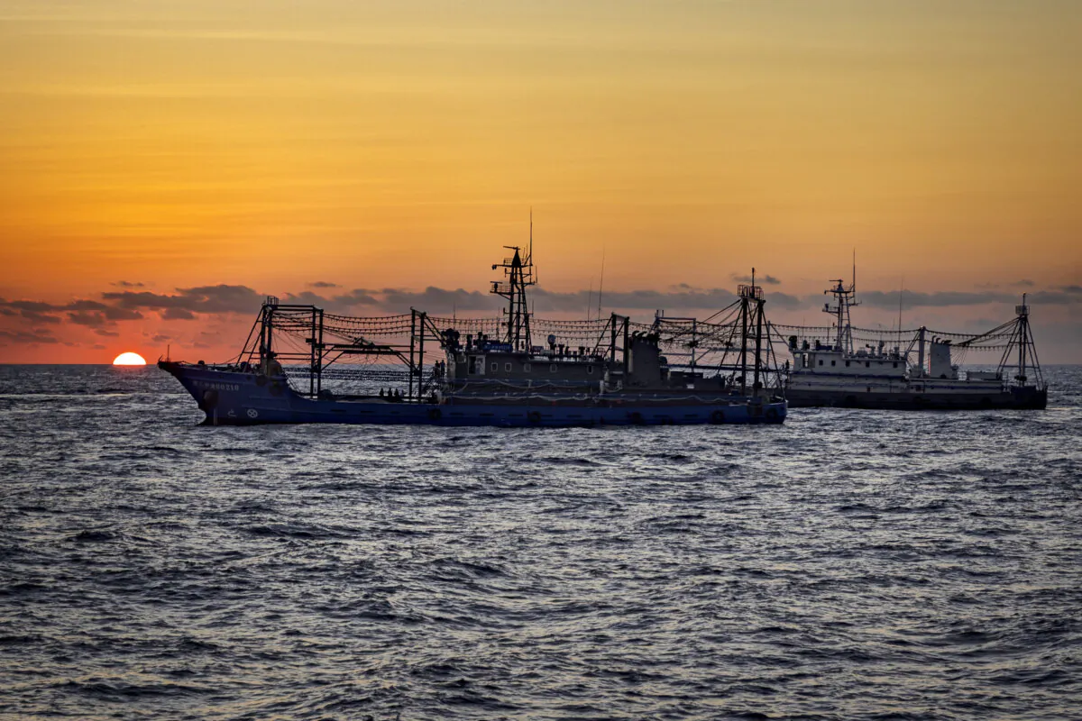 Chinese militia ships are seen as Philippine ships conduct a resupply mission to troops stationed at Second Thomas Shoal in the South China Sea on March 5, 2024. (Ezra Acayan/Getty Images)