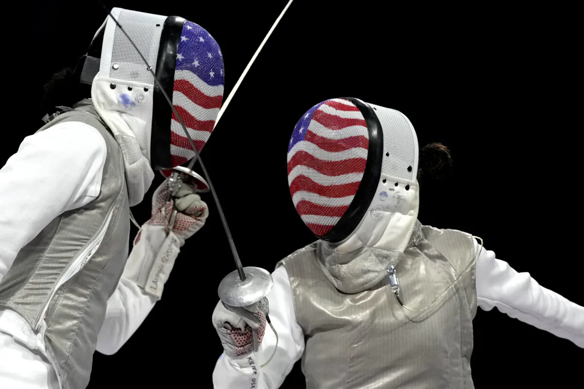 United States' Lee Kiefer (R) competes with United States' Lauren Scruggs in the women's individual Foil final match during the 2024 Summer Olympics at the Grand Palais in Paris, France, on July 28, 2024. (Andrew Medichini/AP Photo)
