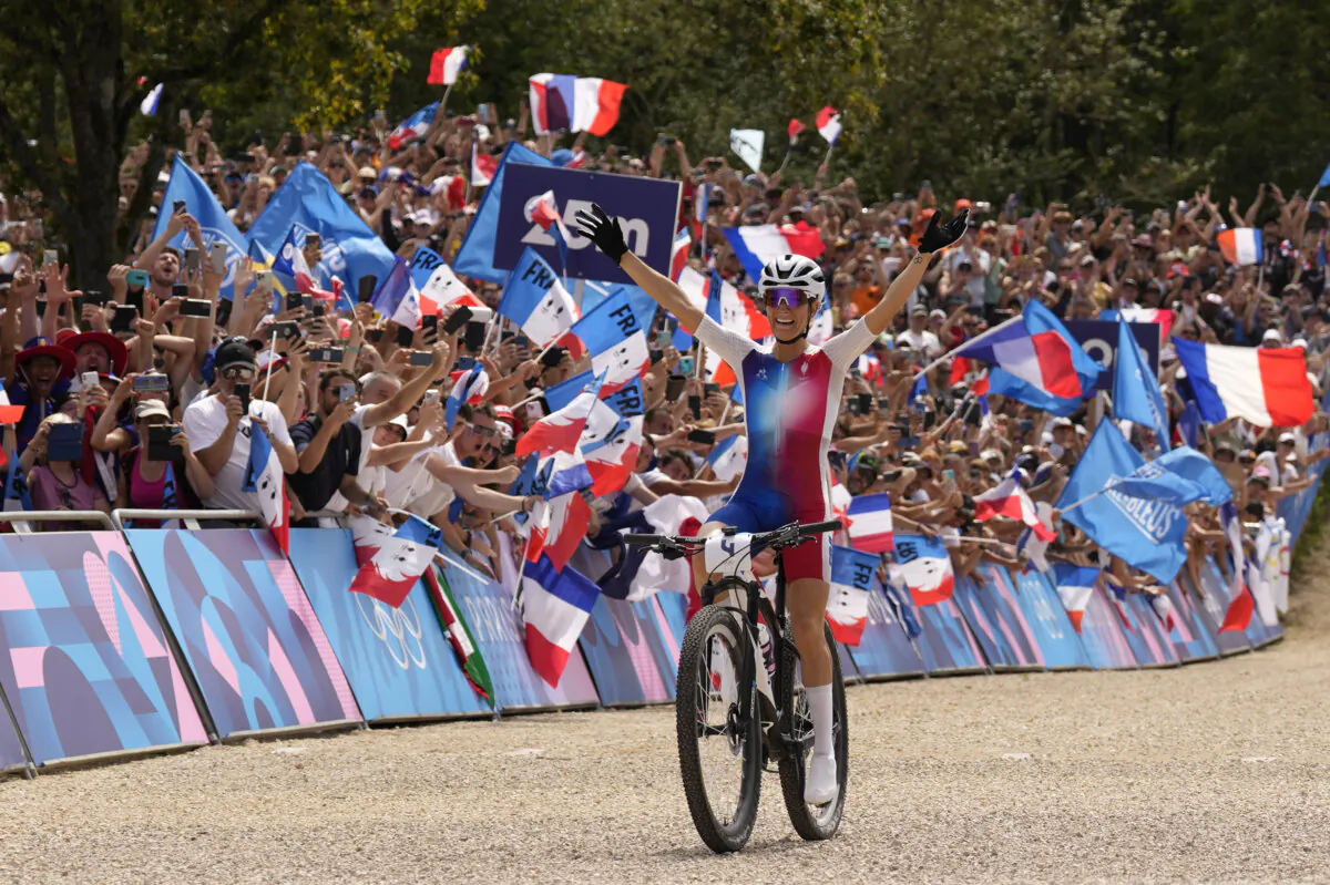 Pauline Ferrand Prevot of France celebrates winning the women's mountain bike cycling event at the 2024 Summer Olympics in Elancourt, France, on July 28, 2024. (George Walker IV/AP Photo)
