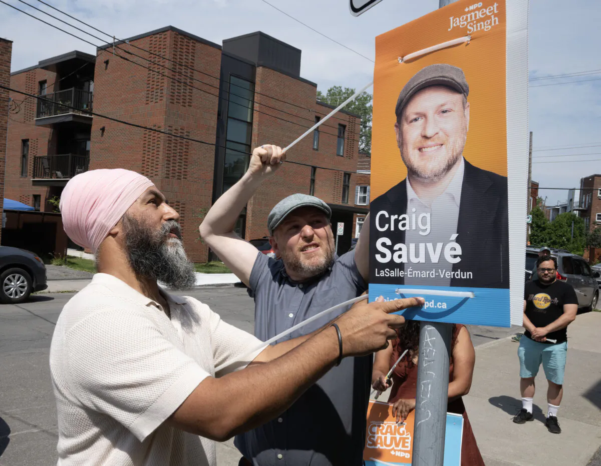 NDP leader Jagmeet Singh puts up campaign posters with candidate Craig Sauvé on July 29, 2024 in Montreal. A federal byelection will be held in the riding of Lasalle-Émard-Verdun Sept. 16, 2024. (Ryan Remiorz/The Canadian Press)