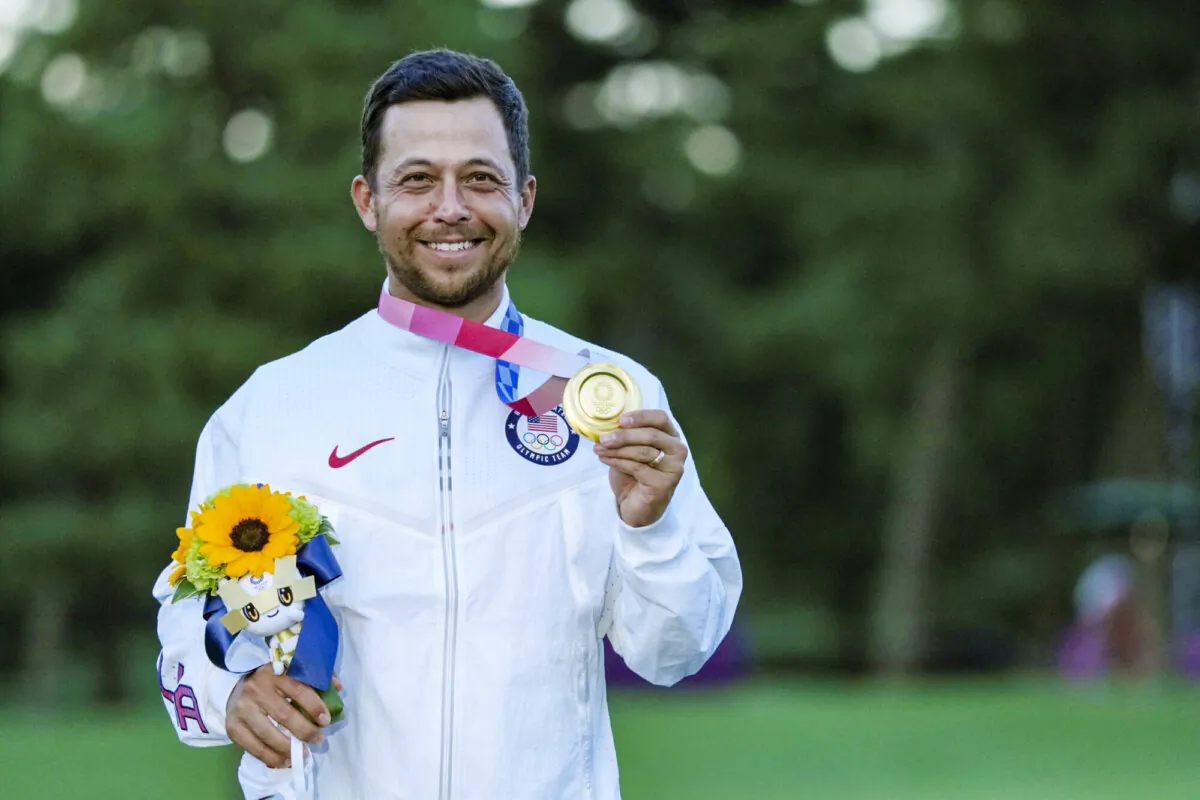 Xander Schauffele, of the United States, holds his gold medal in the men's golf at the 2020 Summer Olympics, in Kawagoe, Japan, on Aug. 1, 2021. (Andy Wong/AP)