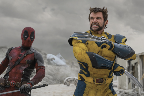 two men, one red costume with sword, one yellow costume with claws in DEADPOOL & WOLVERINE 