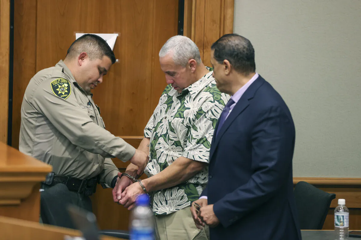 A court officer removes Albert "Ian" Schweitzer's handcuffs following the judge's decision to release him from prison immediately, after spending more than 20 years in prison, Jan. 24, 2023, in Hilo, Hawaii. A man who was identified as a new suspect in the murder and sexual assault of a woman visiting Hawaii more than three decades ago committed suicide after police took a DNA swab from him, but before he could be arrested, attorneys said in court filings late Sunday, July 28, 2024.. The DNA work represented a major development in a case that was in the headlines last year when Schweitzer, ,a man who'd been incarcerated for more than 20 years for the murder, was released based on fresh evidence. (Marco Garcia/The Innocence Project via AP Images)