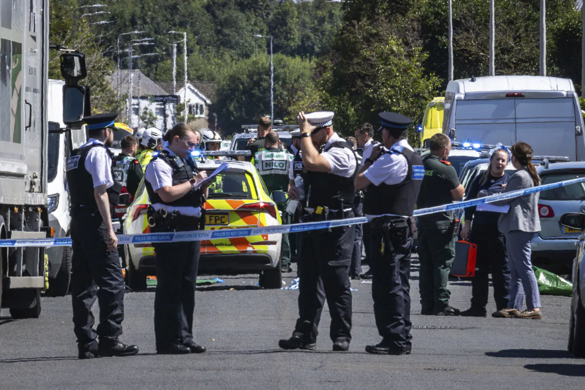 Police secure the area, where a man has been detained and a knife has been seized after a number of people were injured in a reported stabbing, in Southport, Merseyside, England, on July 29, 2024. (James Speakman/PA via AP)
