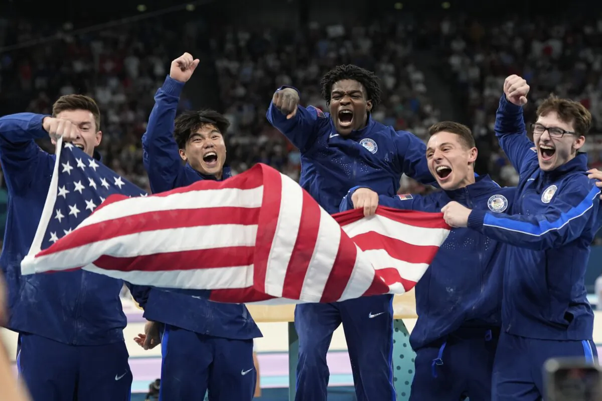 (L–R) Team USA Brody Malone, Asher Hong, Fred Richard, Paul Juda, and Stephen Nedoroscik celebrate their bronze medal during the men's artistic gymnastics team finals round at Bercy Arena at the 2024 Summer Olympics in Paris, France, on July 29, 2024. (Abbie Parr/AP Photo)