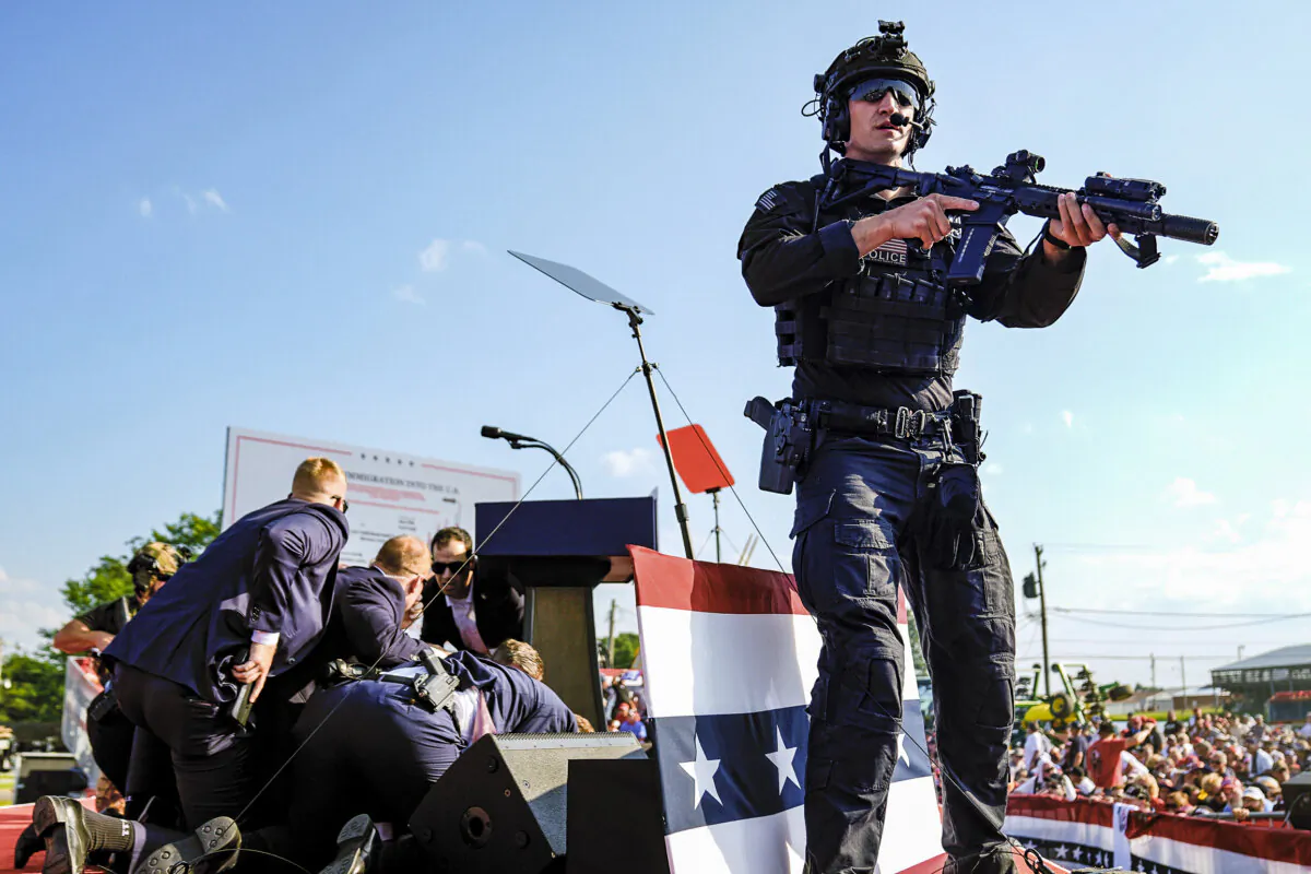 Republican presidential candidate former President Donald Trump is covered by Secret Service agents at a campaign rally in Butler, Pa., on July 13, 2024. (Evan Vucci/AP Photo)