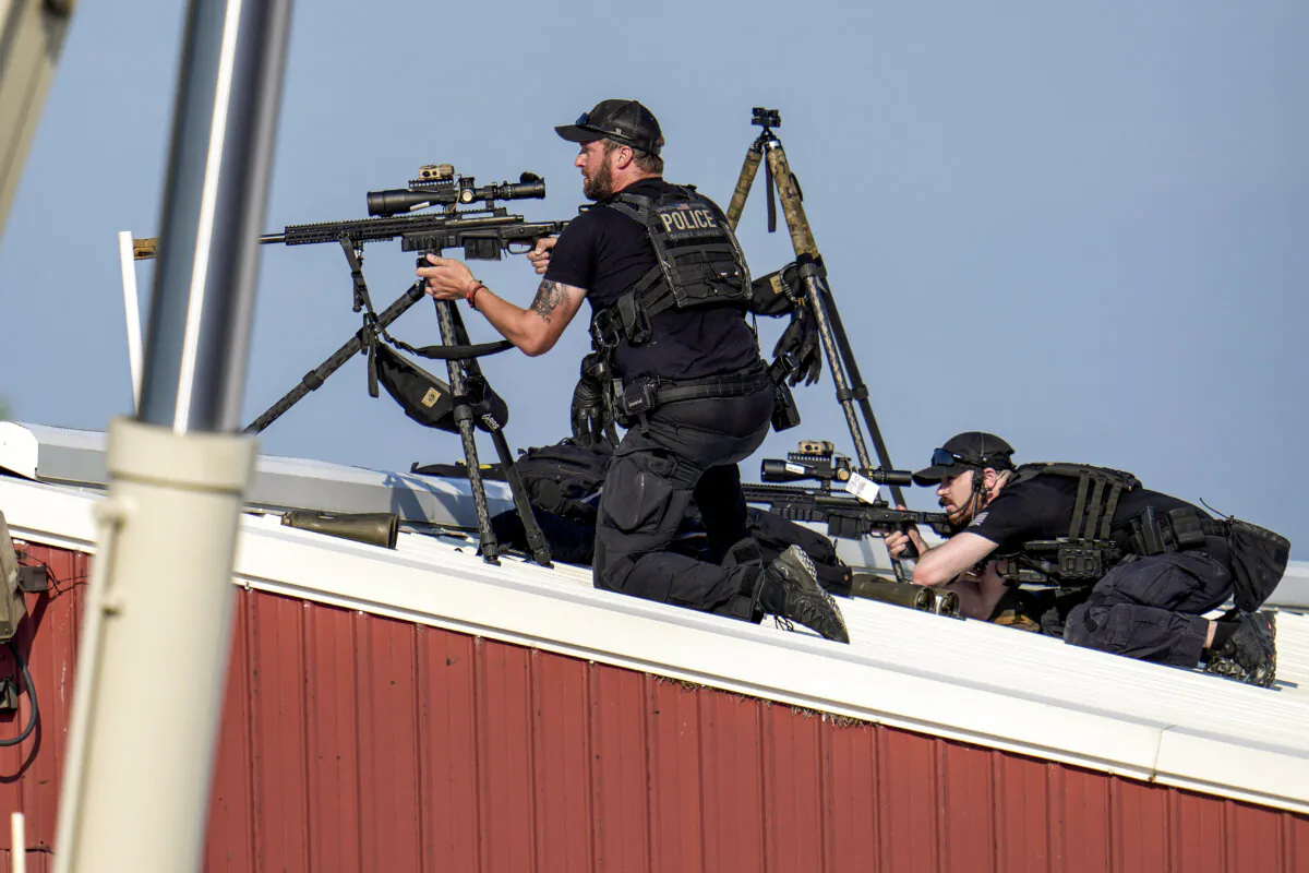 Police snipers on a roof after shots were fired while Republican presidential candidate former President Donald Trump was speaking at a campaign event in Butler, Pa., on Saturday, July 13, 2024. (AP Photo/Gene J. Puskar)
