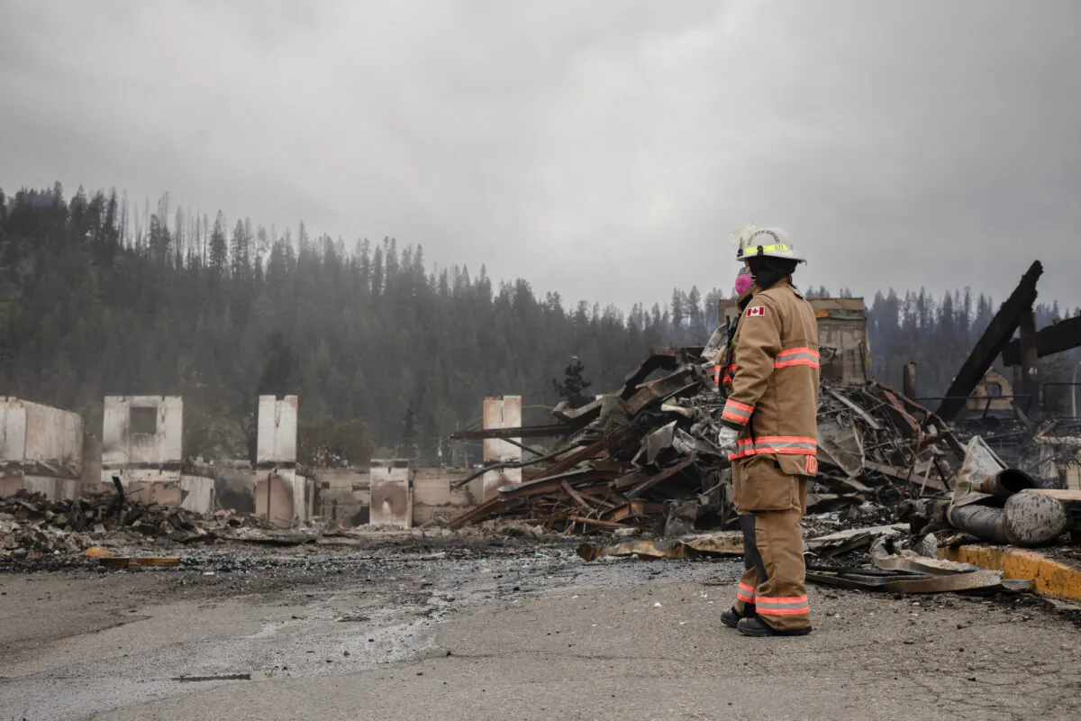 Fire crews work to put out hot spots in the Maligne Lodge in Jasper, Alta., on July 26, 2024. (The Canadian Press/Amber Bracken)