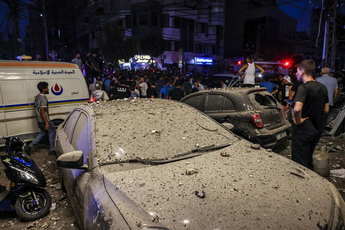 Debris covers vehicles following an Israeli military strike on Beirut's southern suburbs on July 30, 2024. (Anwar Amro/AFP via Getty Images)