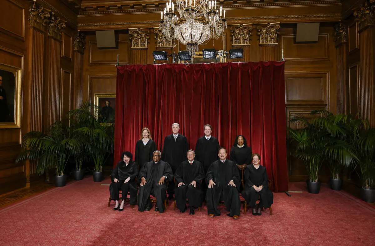 (L–R) Supreme Court Justices Sonia Sotomayor, Amy Coney Barrett, Clarence Thomas, Neil Gorsuch, Chief Justice John Roberts, Associate Justice Brett Kavanaugh, Samuel Alito, Ketanji Brown Jackson, and Elena Kagan pose for a group photo at the Supreme Court on Oct. 7, 2022. (Olivier Douliery/AFP via Getty Images)