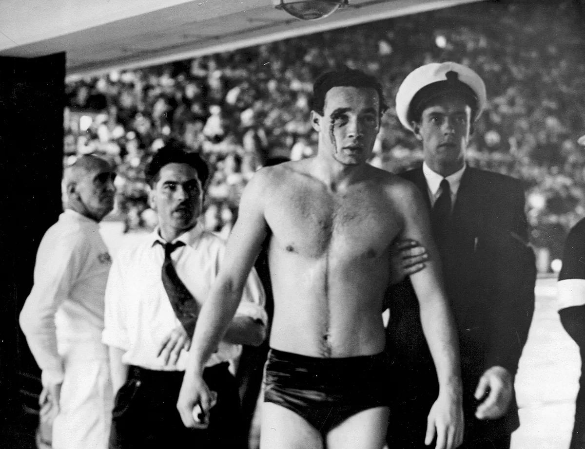 Hungarian Ervin Zador, profusely bleeding from his wounded eye, is escorted from the pool during the water polo match between the Soviet Union and Hungary, in "Freedom's Fury." (Cinergi Pictures Entertainment)