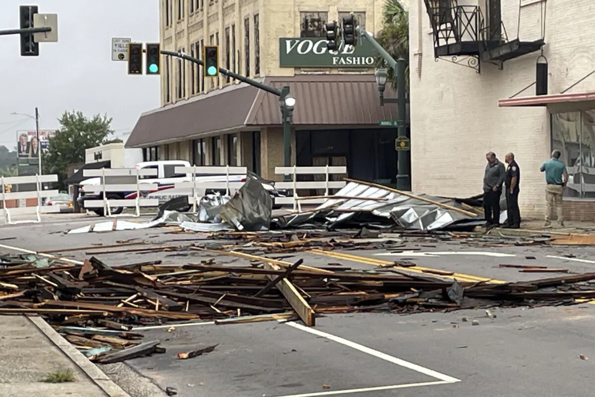 Debris, including pieces of tin from roofs and wood from awnings  lay strewn in the street along Broughton Street on Wednesday, July 31, 2024 after an overnight storm passed the area.  (Dionne Gleaton/The Times and Democrat via AP)