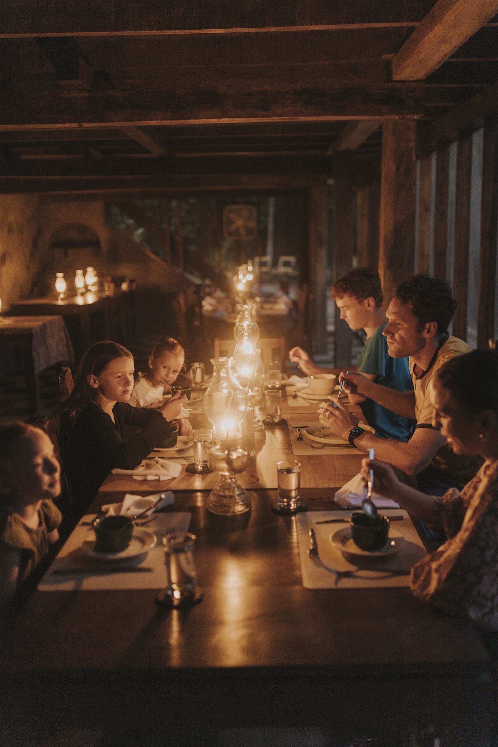 The Walker family enjoyed dinner with a soft lamplight.