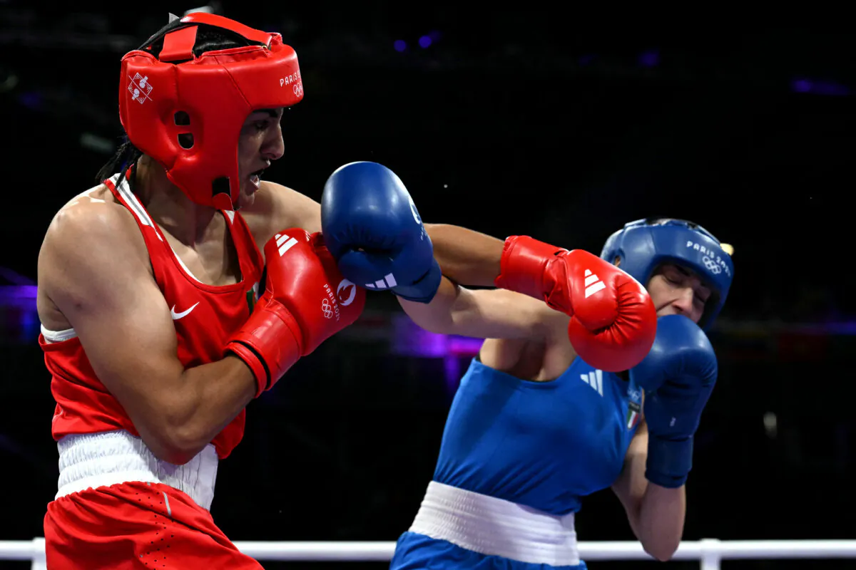 Algeria's Imane Khelif (in red) punches Italy's Angela Carini in a women's 66kg preliminaries round boxing match during the Paris 2024 Olympic Games at the North Paris Arena in Villepinte on Aug. 1, 2024. (Mohd Rasfan/AFP via Getty Images)