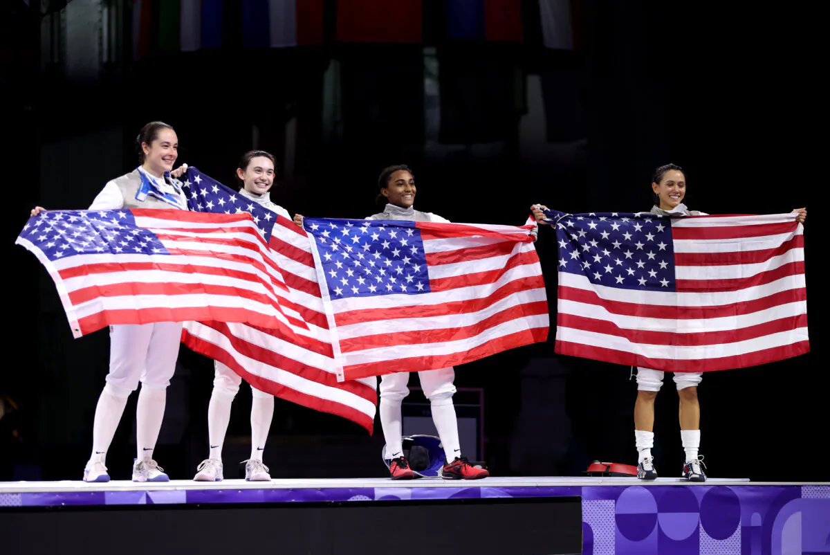 (L-R) Jacqueline Dubrovich, Maia Weintraub, Lauren Scruggs, and Lee Kiefer Team United States celebrate winning against Team Italy during the Fencing Women's Foil Team Gold Medal match on day six of the Olympic Games at Grand Palais in Paris on Aug. 1, 2024. (Clive Brunskill/Getty Images)
