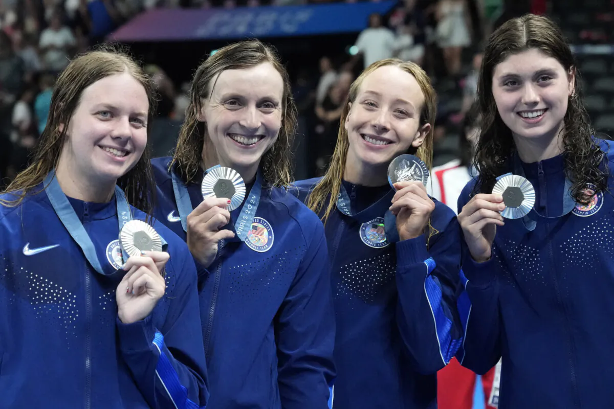 Members of the U.S. women's 4x200-meter freestyle relay team pose with their silver medals at the Summer Olympics in Nanterre, France, on Aug. 1, 2024. (Matthias Schrader/AP Photo)
