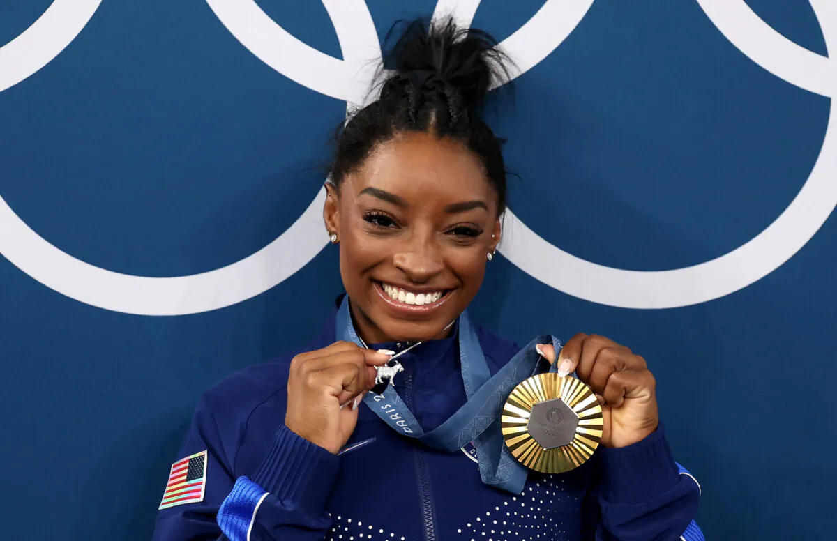 Gold medalist Simone Biles of Team United States poses with the Olympic Rings during the Artistic Gymnastics Women's All-Around Final medal ceremony on day six of the Olympic Games Paris 2024 at Bercy Arena in Paris on Aug. 1, 2024. (Jamie Squire/Getty Images)