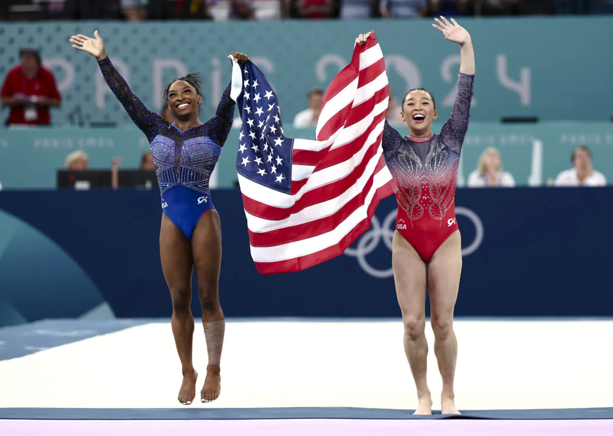 Gold medalist Simone Biles (L) and bronze medalist Sunisa Lee of Team USA celebrate with the American flag after the Artistic Gymnastics Women's All-Around Olympics Final in Paris on Aug. 1, 2024. (Naomi Baker/Getty Images)