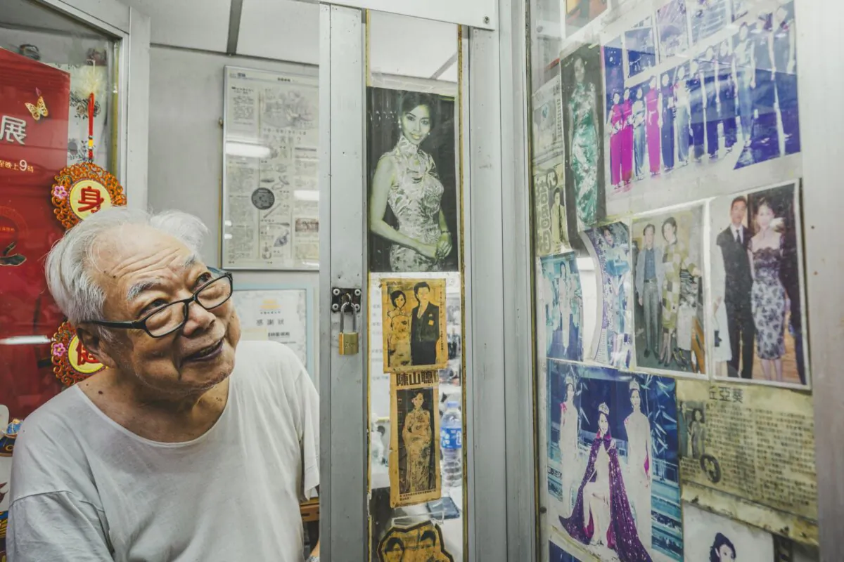 Cheungsam master tailor Ka-man Yan displays photos of celebrities he has dressed in Hong Kong (Lau Wing Hong/The Epoch Times)