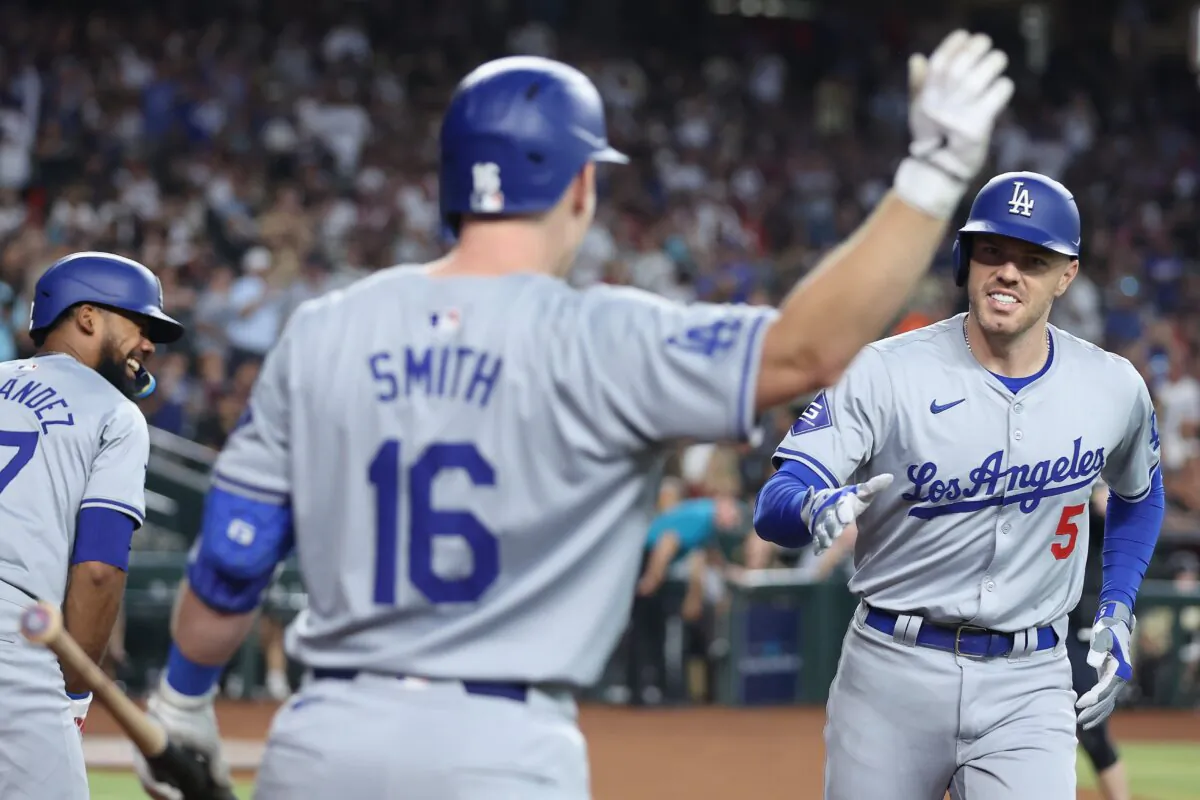 Freddie Freeman (5) of the Los Angeles Dodgers high fives Will Smith (16) after hitting a solo home run against the Arizona Diamondbacks during the first inning of the MLB game in Phoenix on August 31, 2024. (Christian Petersen/Getty Images)