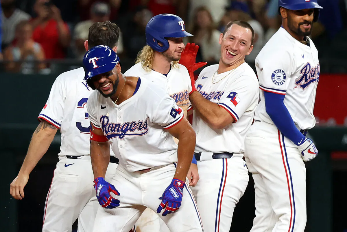 The Texas Rangers celebrate the walk off single by Leody Taveras (3) in the ninth inning for the 3-2 win over the Oakland Athletics in Arlington, Texas, on Aug. 31, 2024. (Richard Rodriguez/Getty Images)