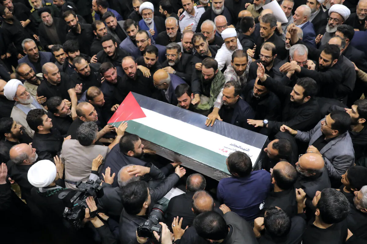 People gather during a funeral procession for Ismail Haniyeh, the political leader of the Hamas terrorist group, and his bodyguard, who were killed in an assassination in Tehran, Iran, the day before, on Aug. 1, 2024. (Office of the Iranian Supreme Leader/Getty Images)