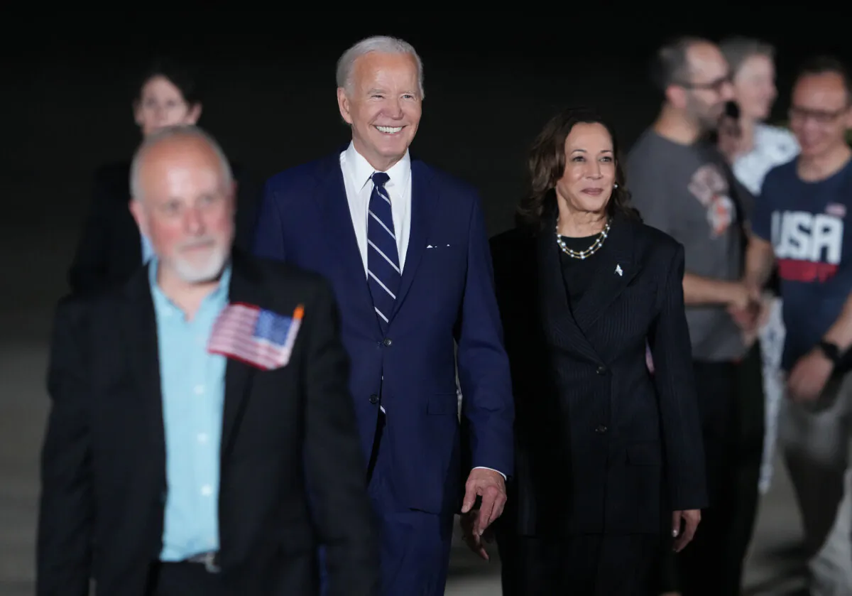President Joe Biden and Vice President Kamala Harris walk on the tarmac after welcoming home freed prisoners Paul Whelan, Evan Gershkovich and Alsu Kurmasheva after they arrived at Joint Base Andrews, Md., on Aug. 1, 2024. (Andrew Harnik/Getty Images)