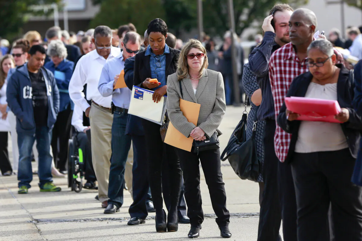 People wait in line to enter the Nassau County Mega Job Fair at Nassau Veterans Memorial Coliseum in Uniondale, N.Y., on Oct. 7, 2014. (Shannon Stapleton/Reuters)