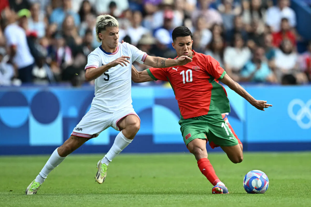 Morocco's forward #10 Ilias Akhomach (R) fights for the ball with United States' defender #05 John Tolkin during the men's quarter-final football match between Morocco and the USA at the Paris 2024 Olympic Games at the Parc des Princes in Paris on Aug. 2, 2024. (Paul Ellis/ AFP via Getty Images)