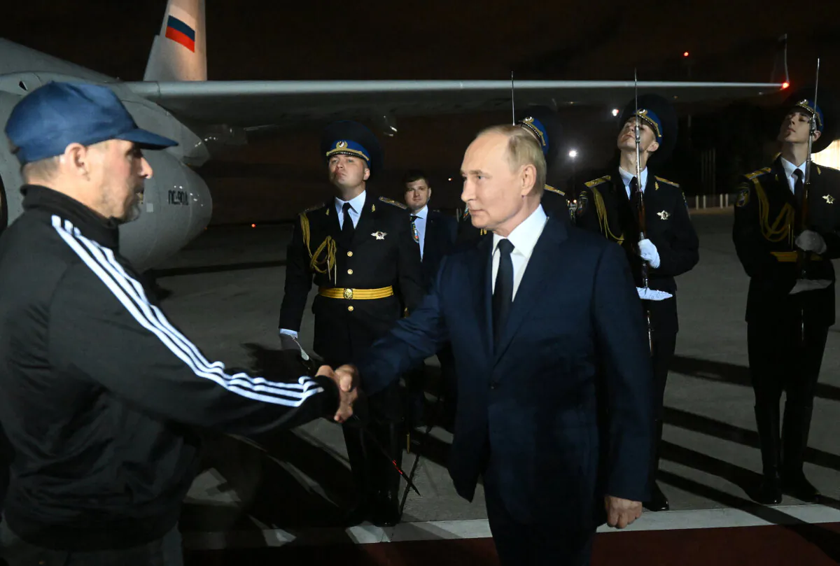 Russian President Vladimir Putin welcomes Vadim Krasikov, as Russian citizens released in a major prisoners swap with the West arrive at Moscow's Vnukovo airport on Aug. 1, 2024. (Mikhail Voskresenskiy/AFP via Getty Images)