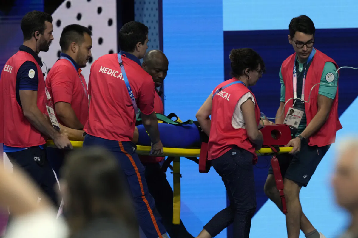 Slovakia’s Tamara Potocka is taken on stretcher from the pool deck after collapsing following a heat of the women's 200-meter individual medley at the 2024 Summer Olympics in Nanterre, France, on Aug. 2, 2024. (Tsvangirayi Mukwazhi/AP Photo)