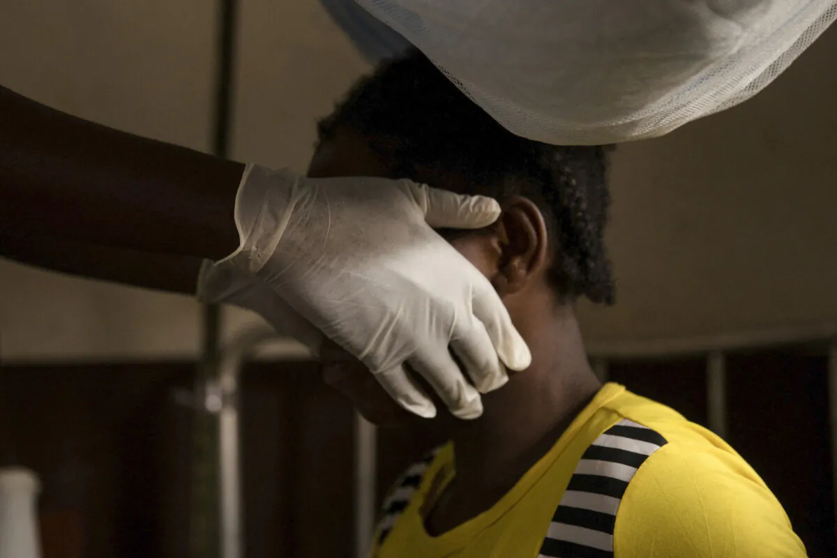 A doctor examines a woman infected with monkeypox in Zomea Kaka, in the Central African Republic, on Oct. 18, 2018. (Charles Bouessel/AFP/Getty Images)