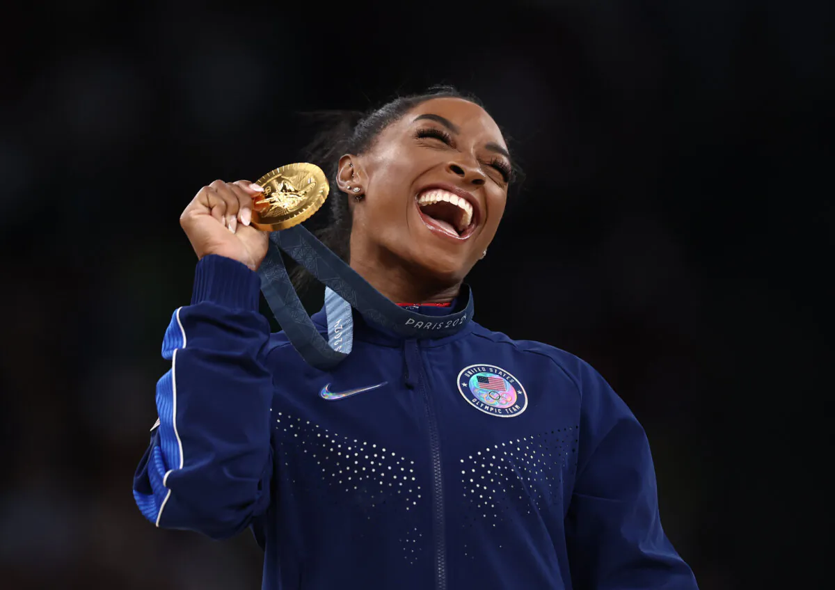 Gold medalist Simone Biles of Team USA celebrates on the podium during the medal ceremony for the Artistic Gymnastics Women's Vault Final on day eight of the Olympic Games Paris 2024 at Bercy Arena in Paris on Aug. 3, 2024. (Naomi Baker/Getty Images)