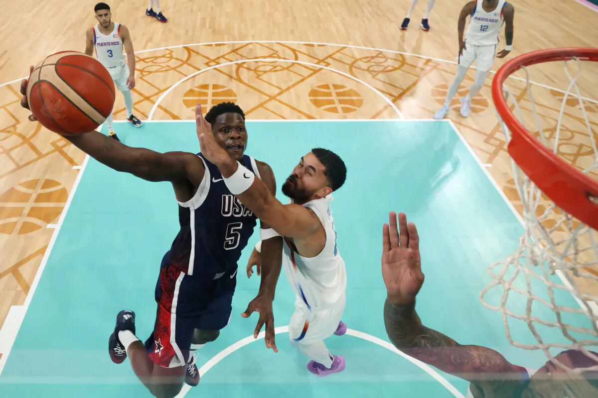 Anthony Edwards #5 of Team United States shoots over Arnaldo Toro #41 of Team Puerto Rico during a Men's basketball group phase-group C game between the United States and Puerto Rico at the Olympic Games at Stade Pierre Mauroy in Lille, France, on Aug. 3, 2024. (Gregory Shamus/Getty Images)