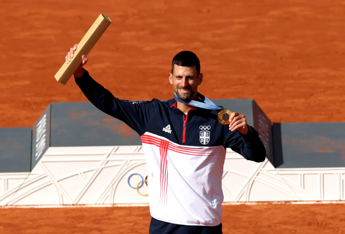 Gold medallist Novak Djokovic of Serbia celebrates on the podium during the tennis men's singles medal ceremony on day nine of the Olympic Games Paris 2024 at Roland Garros in Paris on Aug. 4, 2024. (Matthew Stockman/Getty Images)