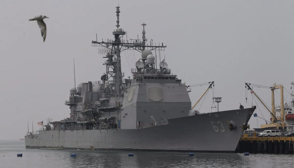 The USS Cowpens, CG 63, a Ticonderoga-class guided-missile cruiser, docks at Manila's pier in the Philippines on March 9, 2014. (AP Photo/Aaron Favila)